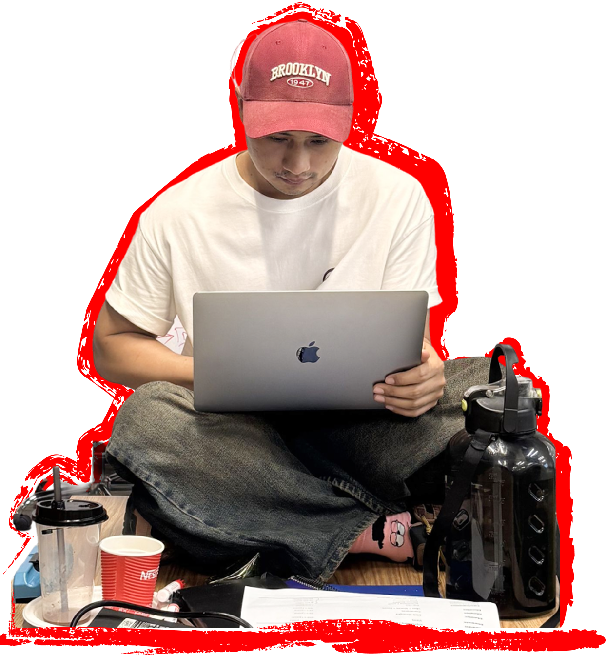 N Admin working at a laptop, surrounded by coffee cups and notes